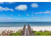 Wooden walkway leads to the beach with ocean views at 507 Casey Key Rd, Nokomis, FL 34275