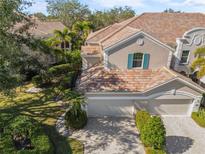 Luxury home with two-car garage, and landscaped grounds at 5248 Bouchard Cir # 201, Sarasota, FL 34238