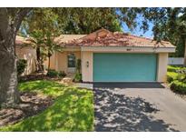 Charming one-story home with teal garage door and landscaped front yard at 607 Marcus St # 27, Venice, FL 34285
