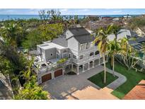 Luxury beachfront home with expansive driveway and ocean views at 8855 Midnight Pass Rd, Sarasota, FL 34242