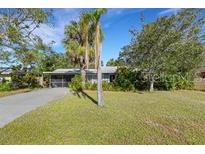 Charming home with mature trees and a lush green lawn creates a welcoming atmosphere and curb appeal at 2669 Prospect St, Sarasota, FL 34239