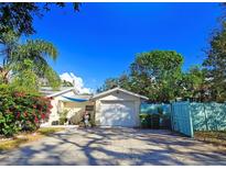 Bright front yard with palm trees and well-maintained landscaping at 3826 Rilma Ave, Sarasota, FL 34234