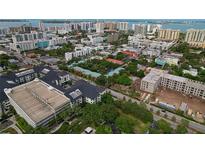Aerial view of a residential community with buildings, parking, and surrounding cityscape at 628 Cohen Way # 628, Sarasota, FL 34236