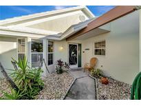 Inviting front entry with walkway, landscaping, and charming door at 805 Harrington Lake N Dr # 76, Venice, FL 34293