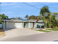 Charming single-story home with attached garage and lush landscaping at 1220 26Th W St, Bradenton, FL 34205
