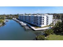 Aerial view of waterfront condo building with boat slips at 1709 N Tamiami Trl # 215, Sarasota, FL 34234