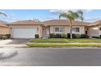 Well-maintained house with a garage and palm tree landscaping at 24181 Green Heron Dr # 84, Punta Gorda, FL 33980