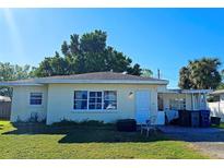 Ranch-style home with a carport and a spacious yard at 3310 Lexington St, Sarasota, FL 34231