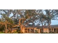 Inviting single-story home with mature trees and well-manicured lawn at 3350 Old Oak Dr, Sarasota, FL 34239