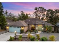 Attractive single-story home with a light-blue garage door and landscaping at 5706 Bent Oak Dr, Sarasota, FL 34232
