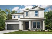 Two-story home with gray siding, dark gray garage door, and landscaping at 6912 Prairie Oak Way, Nokomis, FL 34275
