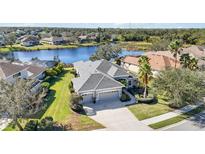 Beautiful waterfront home with a three-car garage and well-manicured lawn at 12343 Lavender Loop, Bradenton, FL 34212