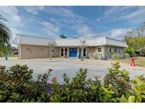 Ranch-style home with stone accents and a bright blue door at 5211 Inverness Dr, Sarasota, FL 34243