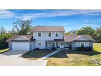 Two-story house with gray siding, brown roof, and stone accents at 6326 Clark Rd, Sarasota, FL 34241