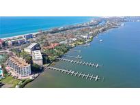 Aerial view of waterfront condo building with ocean and marina views at 8625 Midnight Pass Rd # 505B, Sarasota, FL 34242