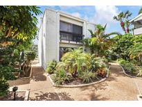 White two-story condo with lush landscaping and walkway at 1555 Tarpon Center Dr # 135, Venice, FL 34285