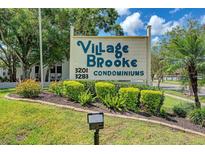 Village Brooke Condominiums sign with lush landscaping at 3255 Beneva Rd # 103, Sarasota, FL 34232