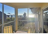 Relaxing screened porch with ocean view and comfortable seating at 5311 Gulf Of Mexico Dr # 6, Longboat Key, FL 34228