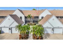 Front view of condo building showcasing attractive landscaping and building architecture at 6609 Stone River Rd # 104, Bradenton, FL 34203