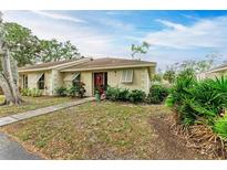 Neatly landscaped exterior of a single-story home with red door at 718 N Jefferson Ave # 718, Sarasota, FL 34237