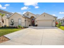 Inviting single-story home with a three-car garage and landscaped front yard at 12259 23Rd E St, Parrish, FL 34219