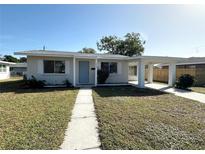 Newly renovated single story home featuring a carport and well manicured lawn at 1605 32Nd W St, Bradenton, FL 34205