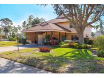 Charming two-story home featuring a covered carport, mature landscaping, and a well-manicured front lawn at 3468 51St Avenue W Dr, Bradenton, FL 34210