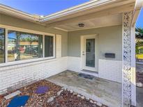 Inviting front porch with white brick accents and decorative support columns welcomes you home at 4001 17Th W Ave, Bradenton, FL 34205