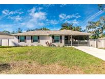 Charming single-story home with a fenced yard, screened porch, and driveway at 5304 Lemon Ave, Seffner, FL 33584