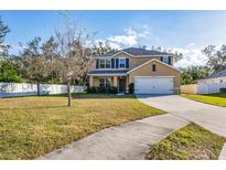 Two-story home with a fenced yard, driveway, and attached garage at 7005 57Th E Ter, Palmetto, FL 34221