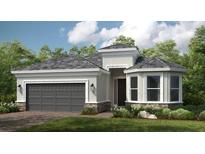 Charming single-story home featuring a gray roof, two-car garage, and beautiful landscaping at 8020 Moonbeam Ave, Sarasota, FL 34241