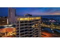 An exterior view of a luxury condominium at twilight with city views at 1255 N Gulfstream Ave # Ph1501, Sarasota, FL 34236