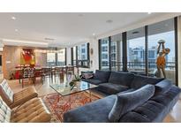 Open-concept living room featuring floor to ceiling windows and modern decor at 1255 N Gulfstream Ave # Ph1501, Sarasota, FL 34236