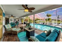 Relaxing poolside patio with wicker furniture and lake view at 2215 39Th W St, Bradenton, FL 34205