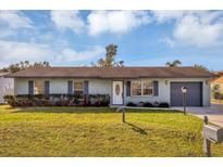 Charming single-story home with a well-manicured lawn and landscaping at 4064 Velarde Ln, Sarasota, FL 34235