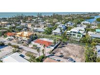Aerial view of a home under construction in a neighborhood with canals at 579 Bayview Dr, Longboat Key, FL 34228