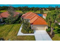 Charming single-story home with a tile roof, landscaped yard, and attached garage at 616 Misty Pond Ct, Bradenton, FL 34212
