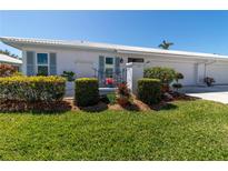 Charming single-story home with a well-manicured lawn, tidy bushes, and a two-car garage at 6913 8Th W Ave, Bradenton, FL 34209