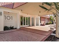 The 101 Condominium entrance features a covered walkway, double doors, and a brick-paved area at 101 S Gulfstream Ave # 15E, Sarasota, FL 34236