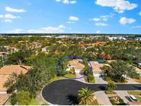 Single-Gathering house with a tile roof nestled in a community of similar homes at 108 Corte Del Rosa, Venice, FL 34285
