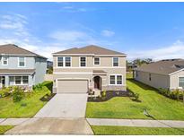 Two-story house with a neutral color scheme and a two-car garage at 5316 Rocky Coast Place, Palmetto, FL 34221