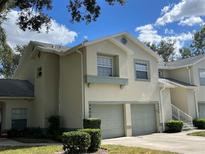 Charming townhouse featuring a two-car garage and well-maintained landscaping under a bright blue sky at 5405 Fair Oaks St # 5405, Bradenton, FL 34203