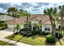 Beautiful home featuring a tile roof, landscaped yard and an attached two car garage at 2112 Calusa Lakes Blvd, Nokomis, FL 34275