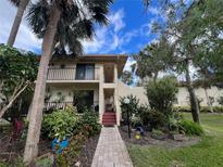 Two-story condo with lush landscaping and a welcoming entryway at 6462 Wild Oak Bay Blvd # 247, Bradenton, FL 34210