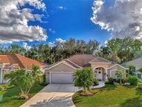 Charming single-Gathering home with a tile roof, landscaped yard, and attached garage at 114 Fieldstone Dr, Venice, FL 34292