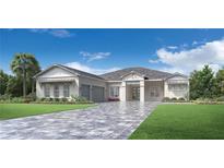 Two-story home with gray roof, two-car garage, and a paved driveway at 17966 Palmiste Dr, Bradenton, FL 34202