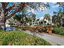 Fairway Bay community entrance with lush landscaping and building exteriors at 1912 Harbourside Dr # 603, Longboat Key, FL 34228