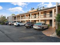 Exterior view of condo building with ample parking at 2522 Clubhouse Dr # 204, Sarasota, FL 34232