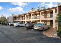 Condo building with parking and balconies at 2522 Clubhouse Dr # 204, Sarasota, FL 34232