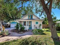 Charming bungalow with a white picket fence and landscaped yard at 2724 Ashton Rd, Sarasota, FL 34231
